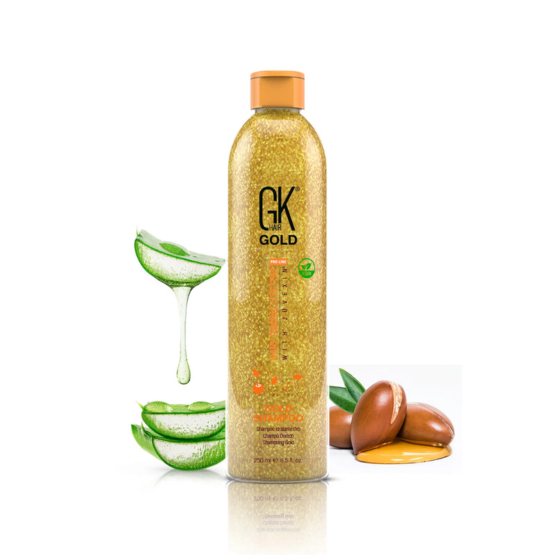 GK Hair Gold Shampoo 250 ml gold glitter bottle with an orange cap, beside dripping aloe vera slices and argan nuts in golden oil