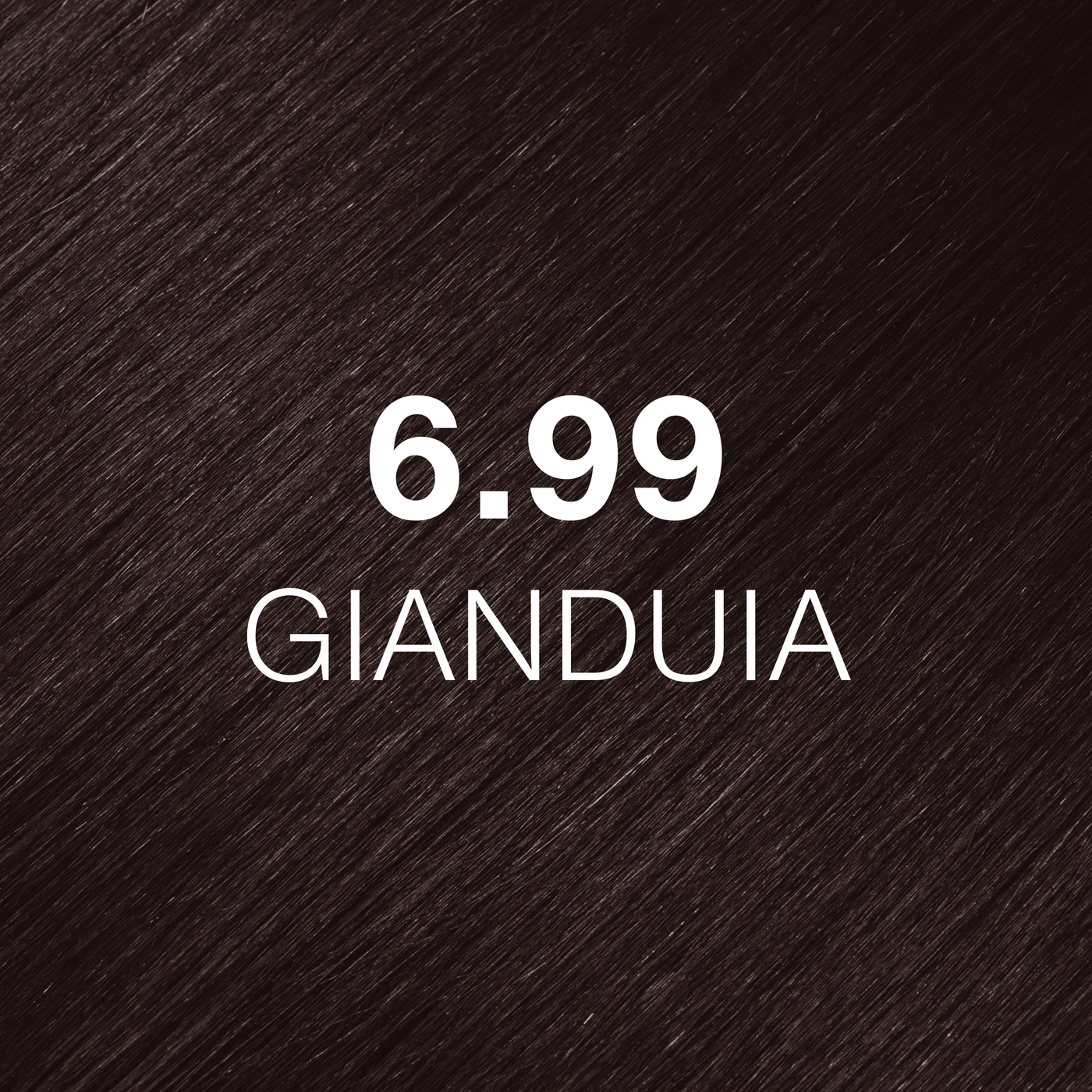 Silky hair texture showcasing the GK Hair's Juxevin Cream Color "6.99 Gianduia" in bold white text.
