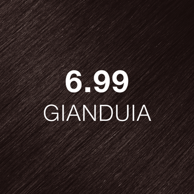 Silky hair texture showcasing the GK Hair's Juxevin Cream Color "6.99 Gianduia" in bold white text.