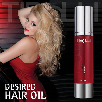 A Model Shocasing After Using Desired Hair Oil With the Product beside her with a Dark Background