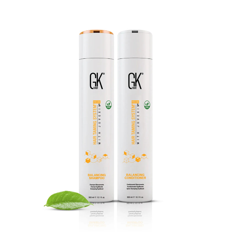 GK Hair Balancing Shampoo and Balancing Conditioner, both 300 ml, with a green leaf in the foreground.