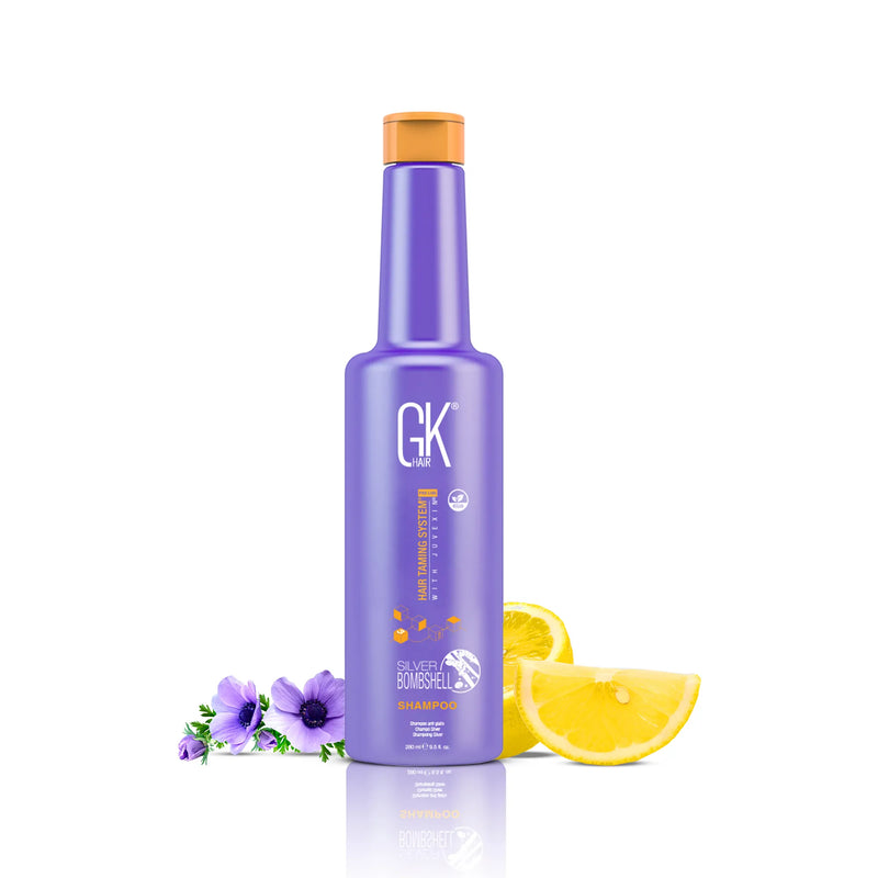 GK Hair Silver Bombshell Shampoo 280 ml purple bottle with an orange screw cap, purple anemones and lemon slices beside it