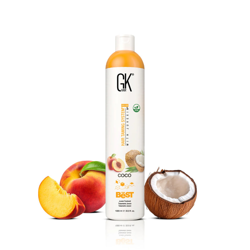 GK Hair's The Best Coco 1000ml in-between a broken coconut and a whole apple alongside a sliced apple