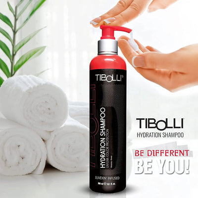 A Tibolli Hydration Shampoo with a pump dispenses product, alongside rolled white towels and a green plant in a bright setting.